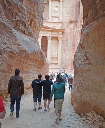 Tourists take photos of Petra’s Treasury, the rose-red city's iconic façade, as they walk through the Siq, a 1.2km-long gorge leading to the Treasury, 235km south of Amman, in this file photo (JT file photo)